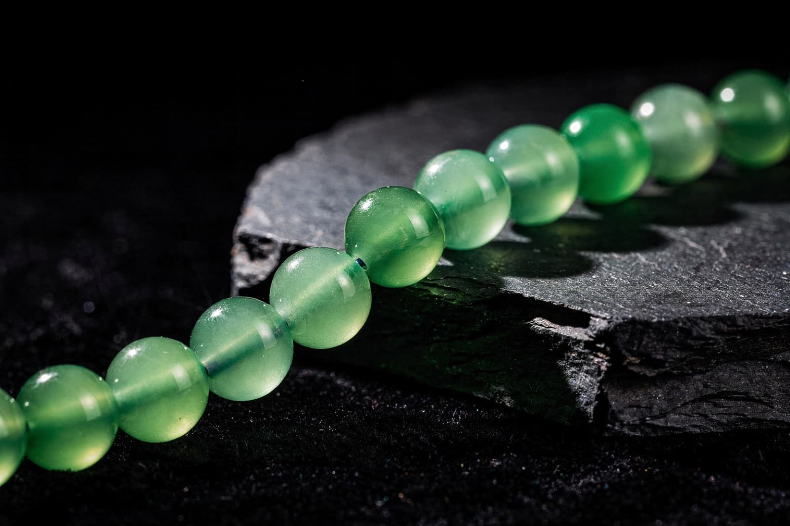 Green onyx and green aventurine beads, styled illustration