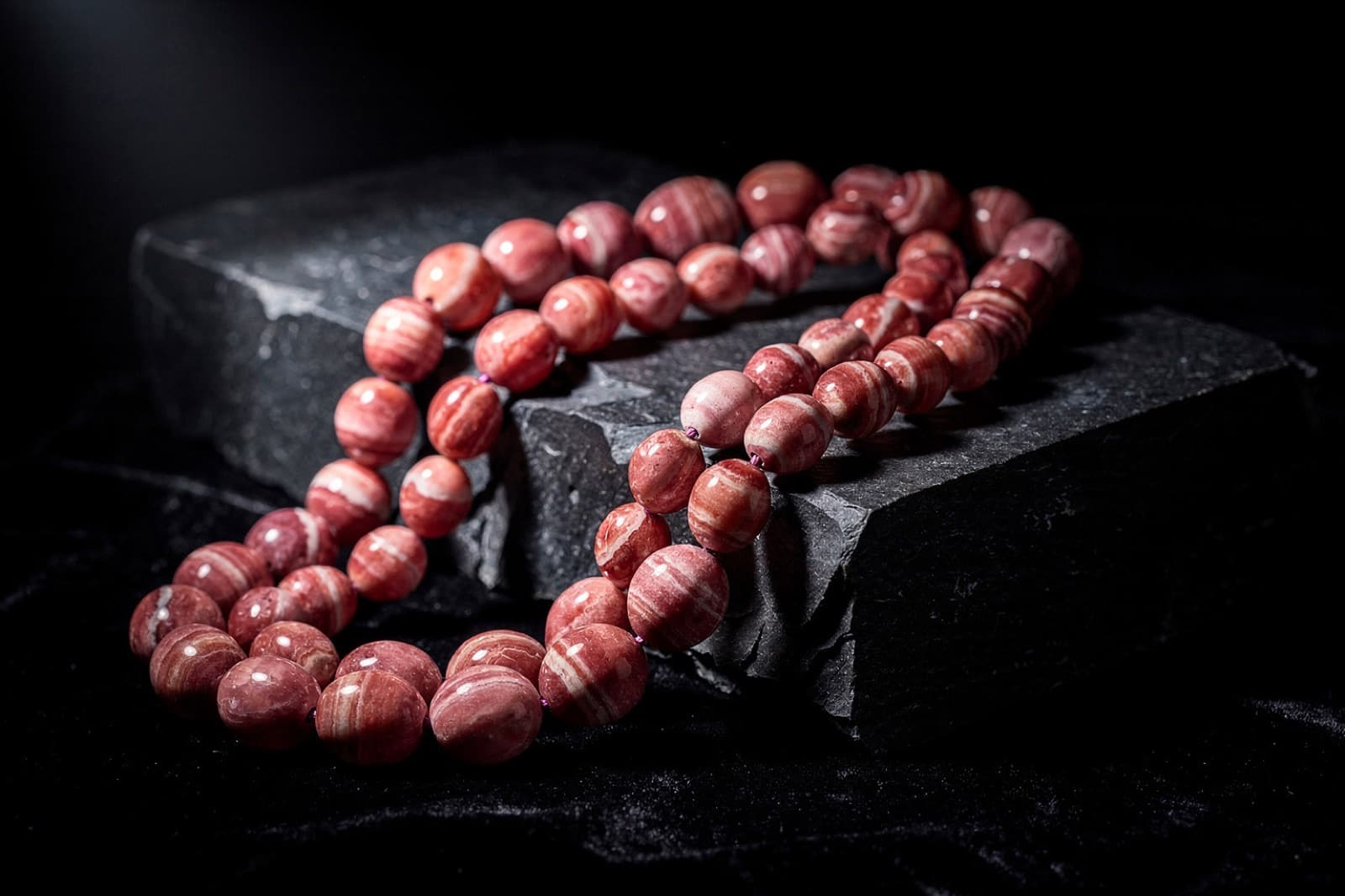 Rhodochrosite beads, styled illustration