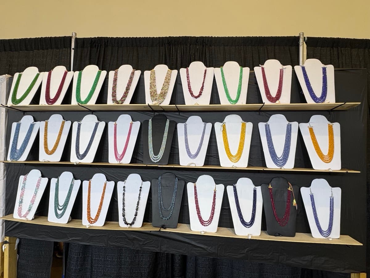 Finished multi-strand necklaces on display at the booth