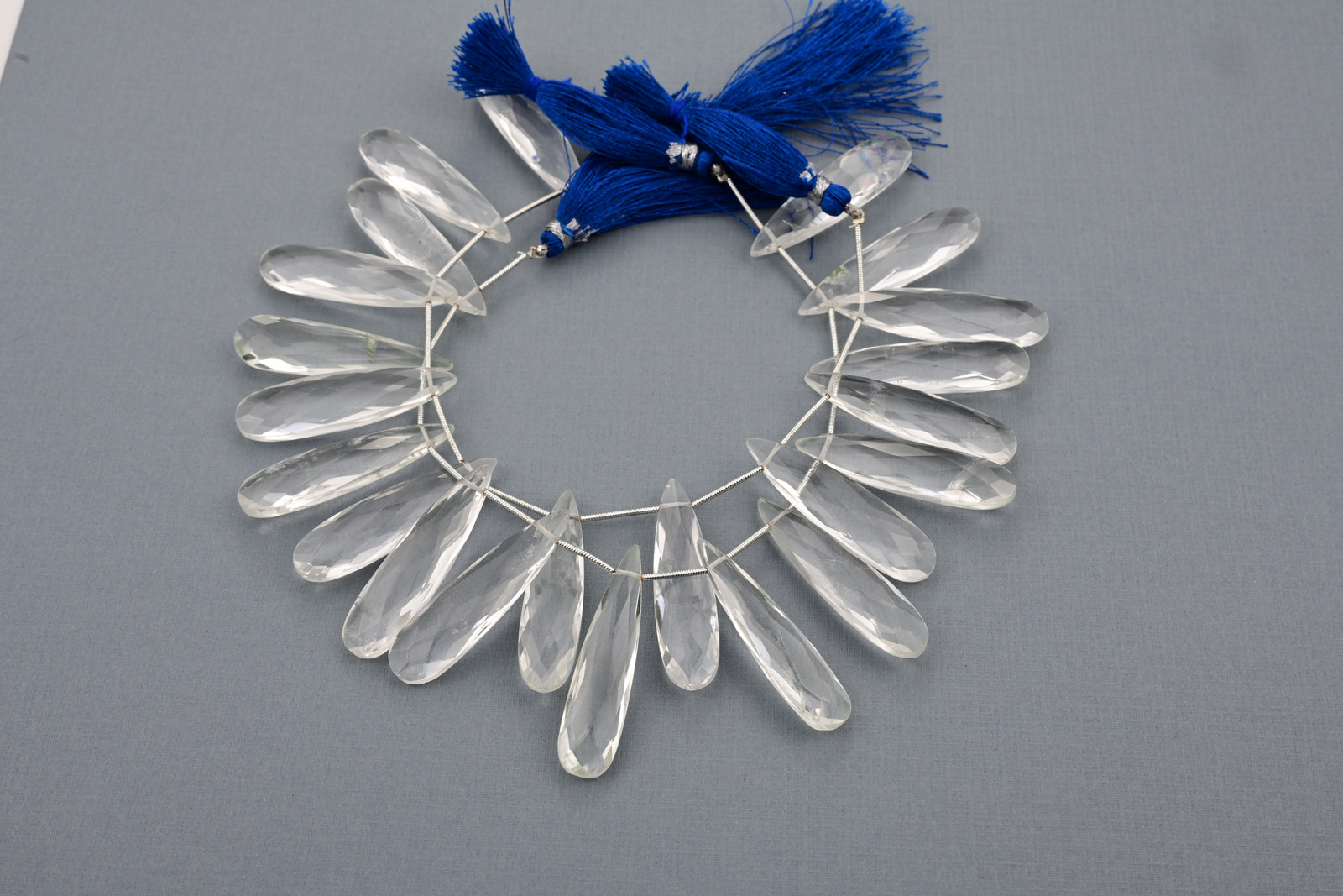 Crystal quartz and golden rutilated quartz strand, a photograph from the Tandon Gems archive