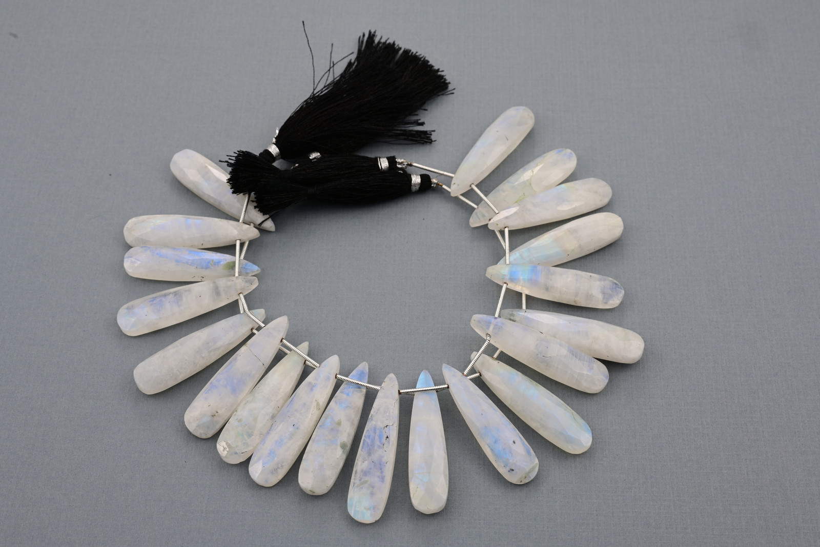 Rainbow moonstone strand, a photograph from the Tandon Gems archive