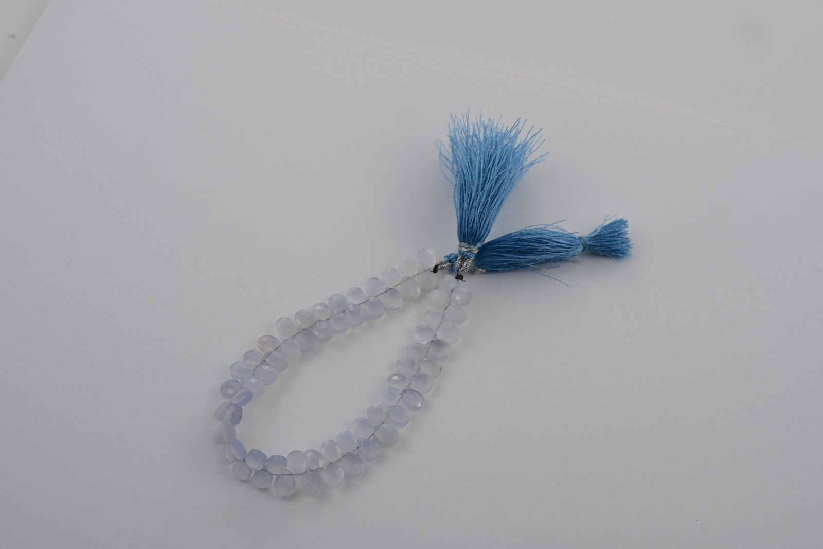 Blue and lavender chalcedony strand, a photograph from the Tandon Gems archive